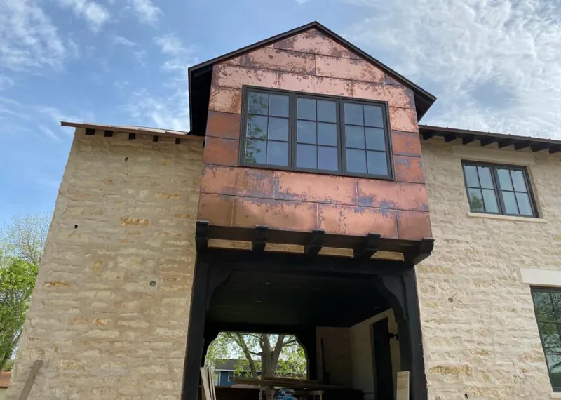 Copper metal panel facade on a stone building for Roof Repair in Lago Vista