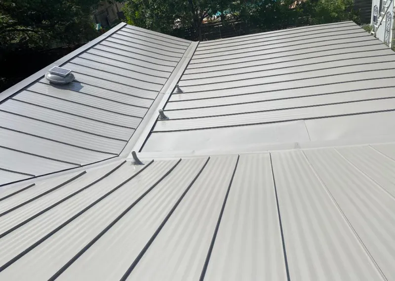 Solar attic fan installed on a metal roof for Roof Ventilation in Lago Vista
