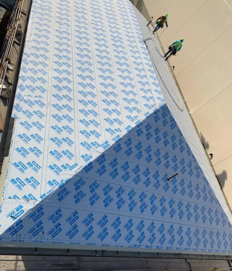 Professional roofers installing underlayment on a metal roof in Lago Vista